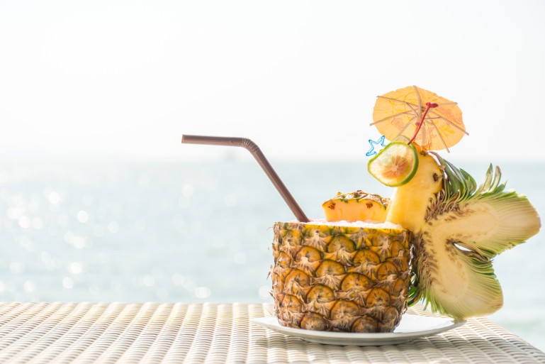 Pineapple cocktail with beautiful sea in background
