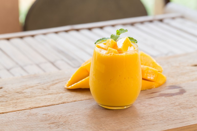 mango smoothies juice and ripe mango fruits.